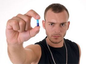 a man holding a potency pill